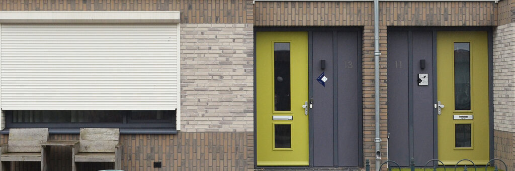 Sociale huurwoning met een groene voordeur en rolluiken