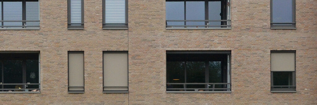 Appartementencomplex met bruine bakstenen gevel en bruine kozijnen