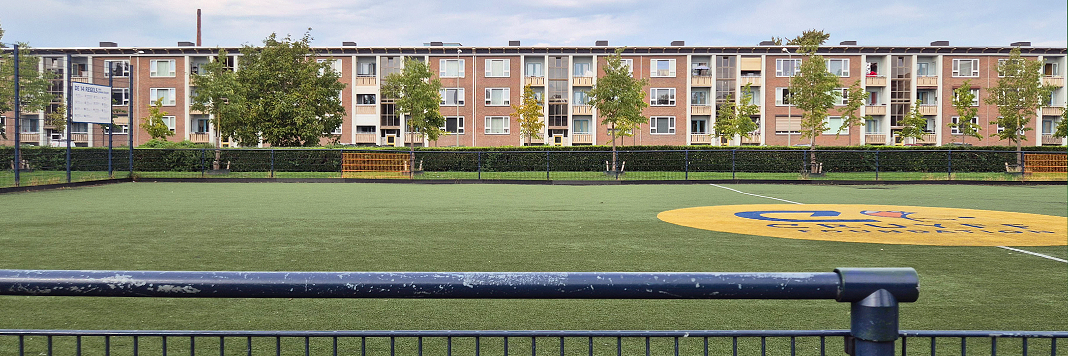 flatgebouw met voorliggend een Johan Cruyff voetbal veldje